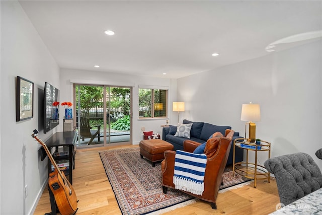 living room with light wood-type flooring and recessed lighting