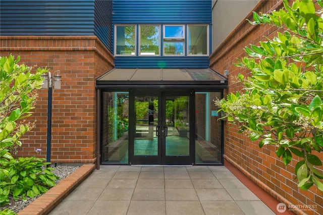 doorway to property with french doors and brick siding