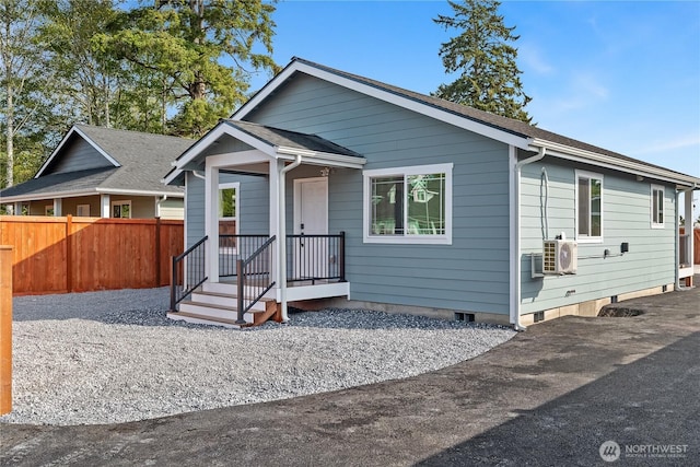 bungalow-style house featuring roof with shingles, crawl space, and fence