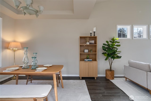 dining space featuring dark wood-style floors and baseboards