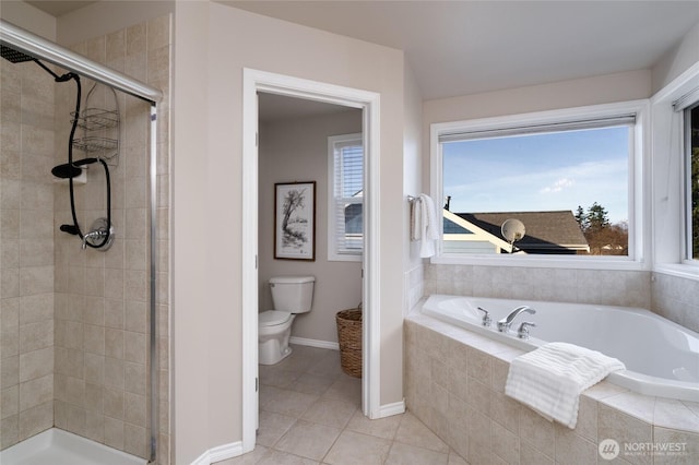 full bath featuring a stall shower, baseboards, toilet, tile patterned floors, and a bath