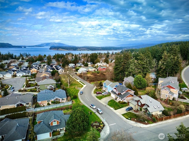 drone / aerial view with a residential view and a water view