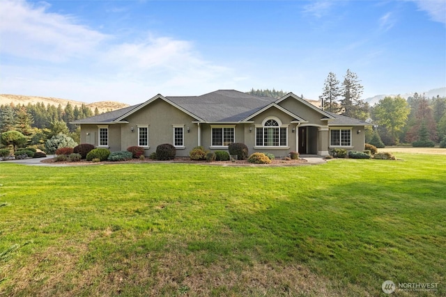 single story home featuring a front yard and stucco siding