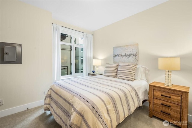 carpeted bedroom featuring electric panel and baseboards