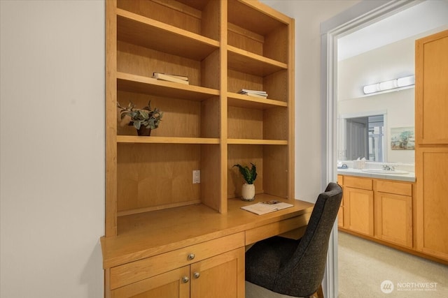 office area featuring a sink and built in desk