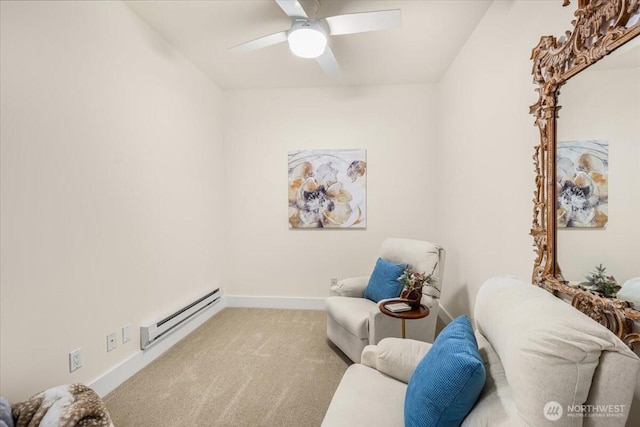 sitting room featuring baseboard heating, carpet flooring, a ceiling fan, and baseboards