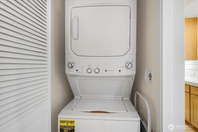 laundry room featuring laundry area and stacked washer / dryer