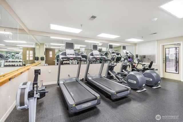 gym with a healthy amount of sunlight, baseboards, and visible vents