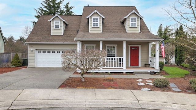 new england style home with covered porch, driveway, roof with shingles, and an attached garage