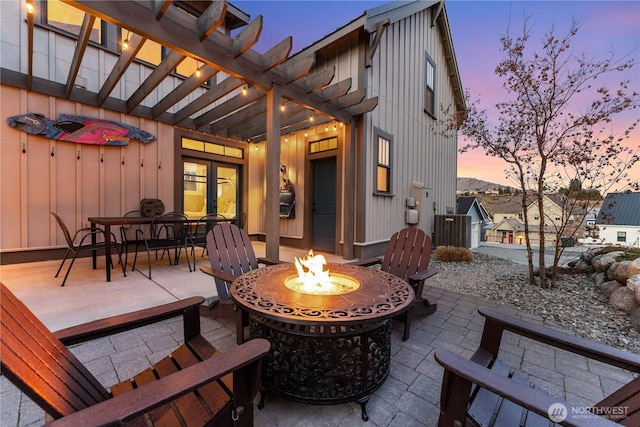 view of patio / terrace with an outdoor fire pit, french doors, and outdoor dining space