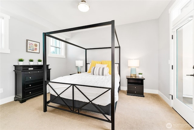 bedroom featuring light carpet and baseboards