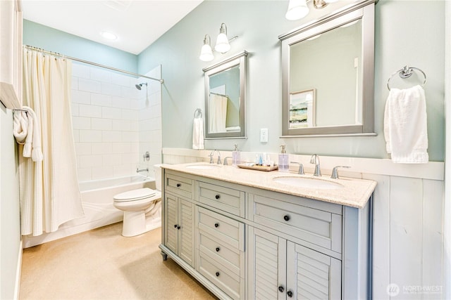 full bath with double vanity, shower / bath combo, a sink, and toilet