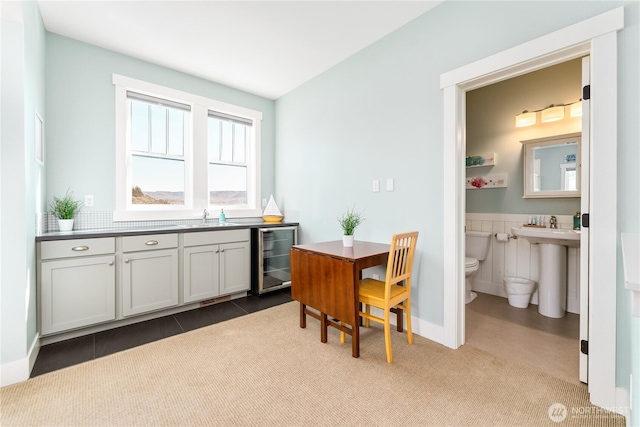 dining area with carpet floors, tile patterned flooring, and wine cooler