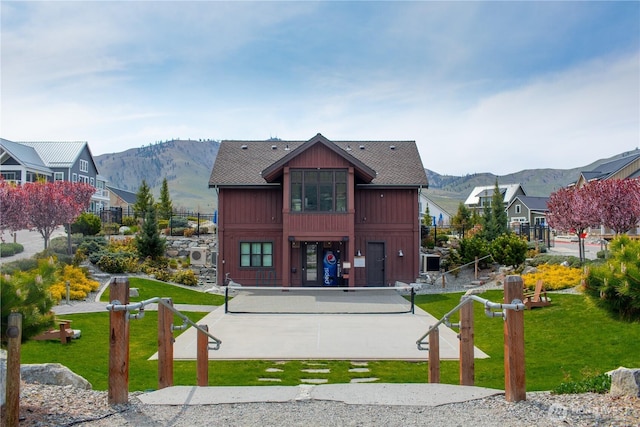 exterior space featuring a yard, fence, and a mountain view