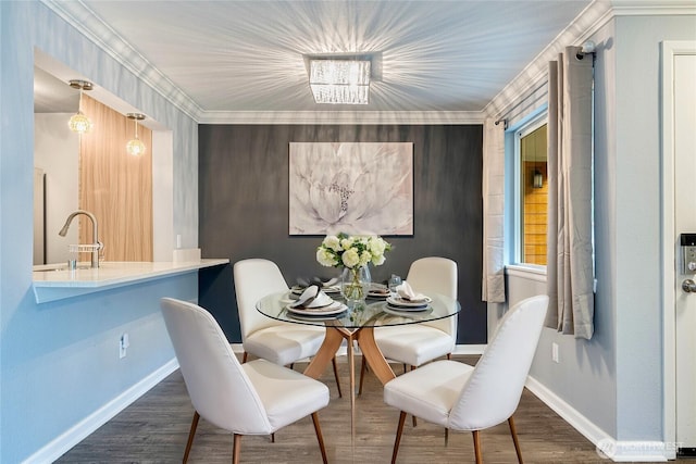 dining space featuring ornamental molding, wood finished floors, and baseboards