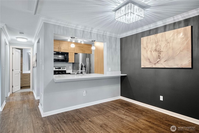 kitchen featuring dark wood-style flooring, crown molding, light countertops, appliances with stainless steel finishes, and a peninsula