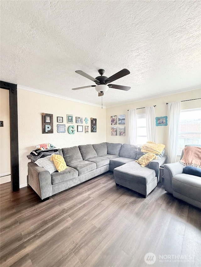 living room with ornamental molding, a baseboard radiator, dark wood finished floors, and a ceiling fan