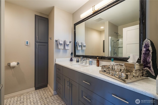 full bathroom featuring baseboards, visible vents, vanity, and walk in shower