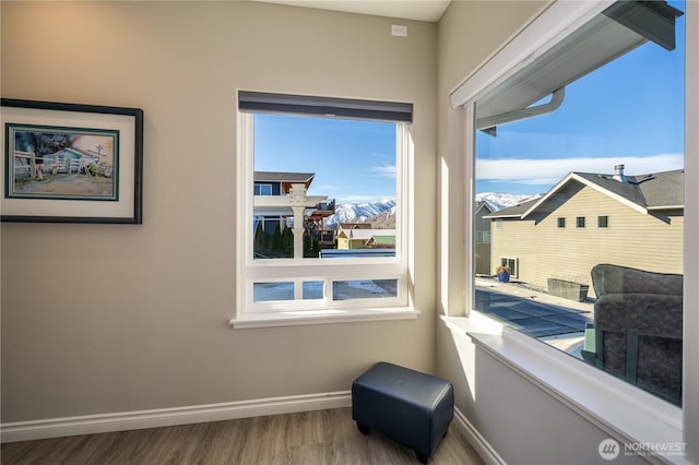 sitting room featuring baseboards and wood finished floors