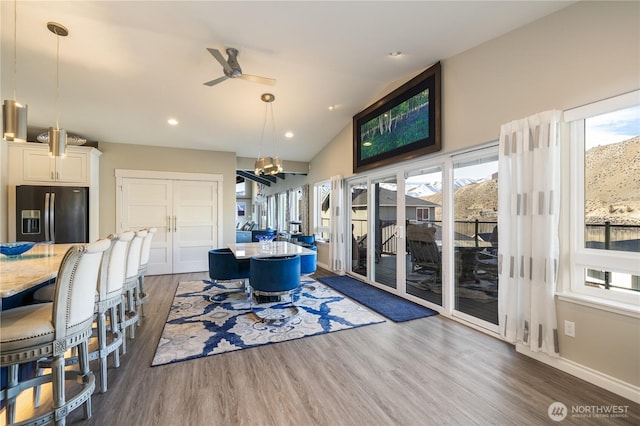 dining area with vaulted ceiling, baseboards, dark wood-style flooring, and a wealth of natural light