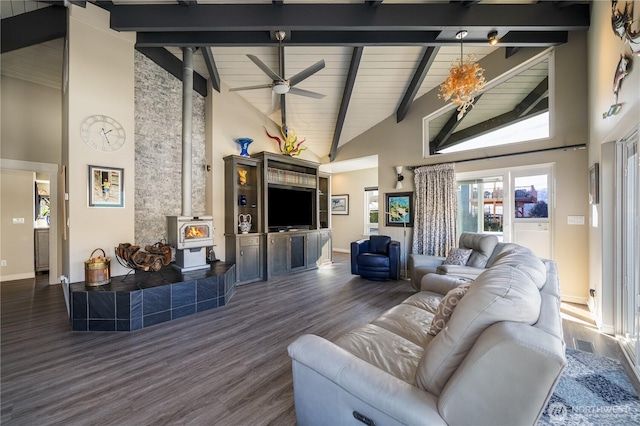 living area featuring beamed ceiling, high vaulted ceiling, a wood stove, and wood finished floors