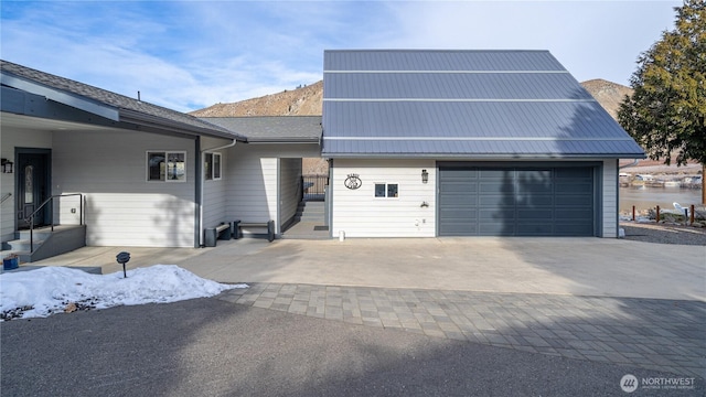 view of front of property featuring metal roof and decorative driveway