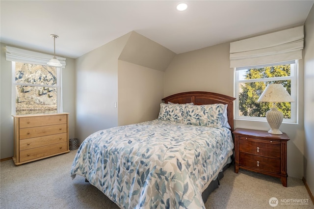 bedroom with light carpet and vaulted ceiling