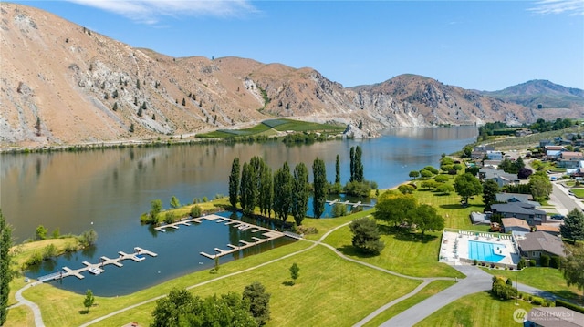 drone / aerial view with a water and mountain view