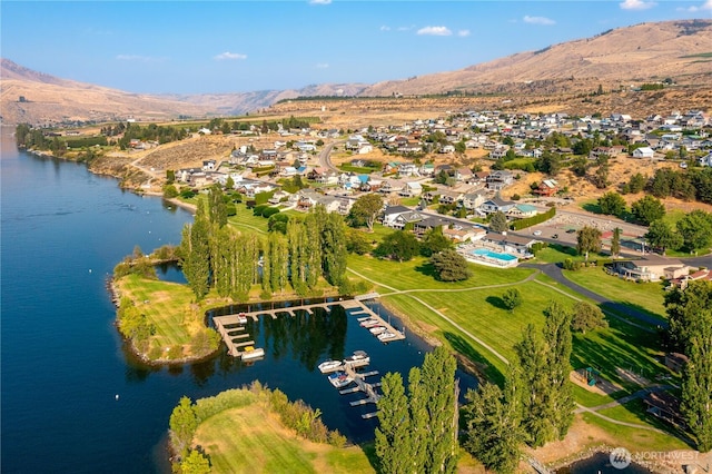 birds eye view of property with a water and mountain view