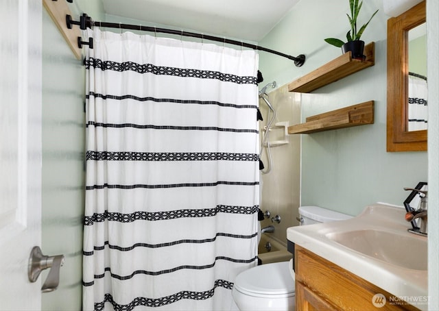 bathroom with shower / bath combo, vanity, and toilet