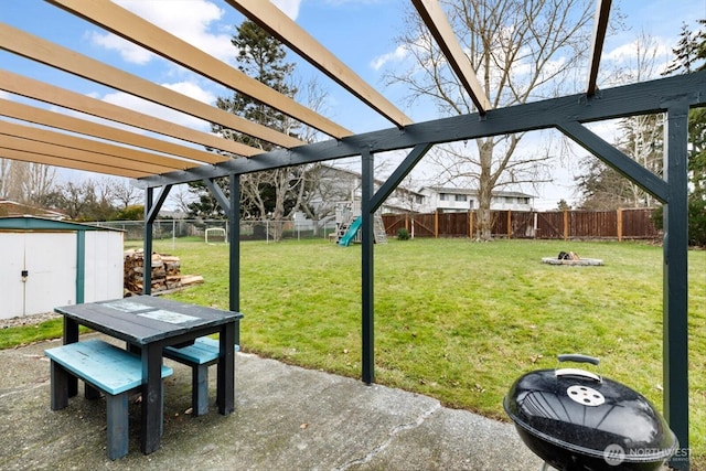 view of yard with a patio, a shed, an outdoor structure, and a fenced backyard