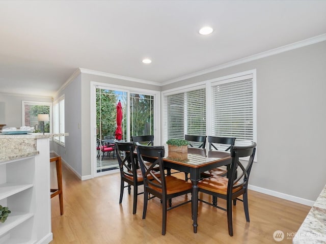 dining space with light wood-style floors, baseboards, crown molding, and recessed lighting