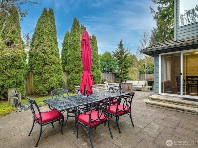 view of patio featuring outdoor dining area, a fenced backyard, and outdoor lounge area