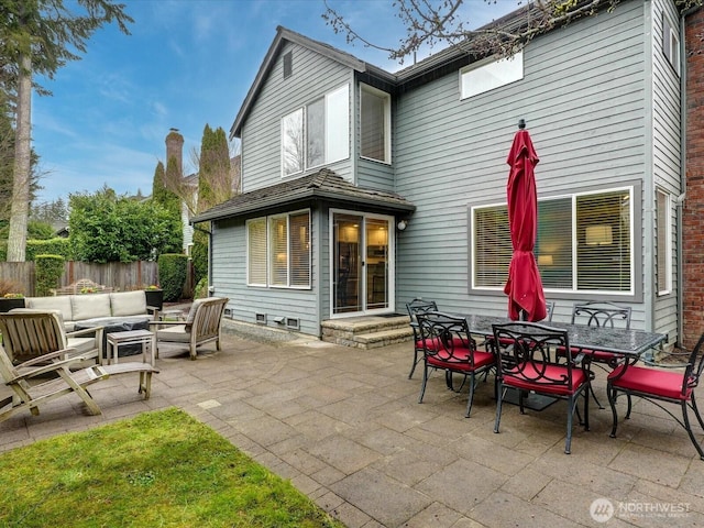 rear view of house with outdoor dining area, fence, outdoor lounge area, and a patio