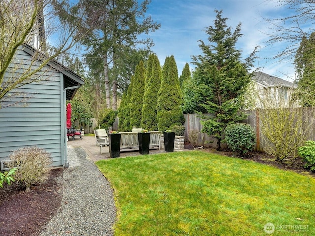 view of yard with a patio area, fence, and an outdoor living space