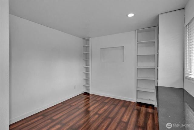 unfurnished bedroom featuring baseboards, dark wood-style flooring, and recessed lighting