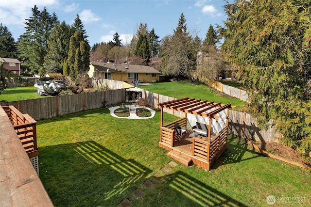 view of yard with a fenced backyard, a deck, and a pergola