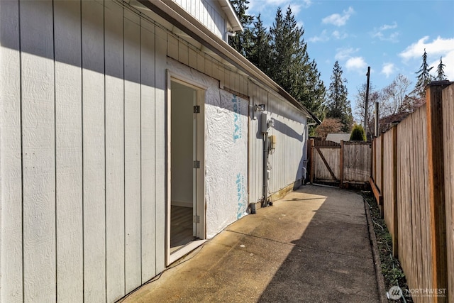 view of side of home with a patio and fence