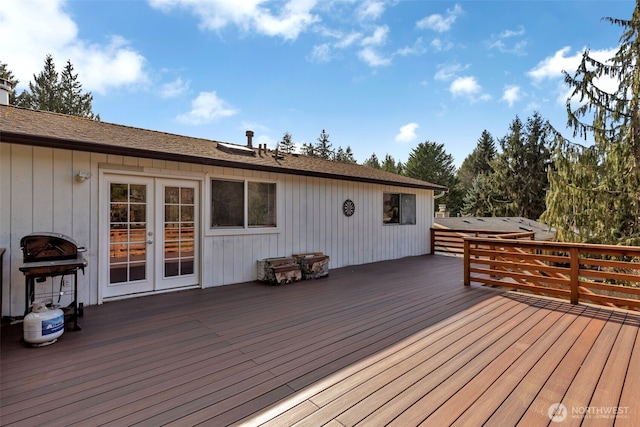 wooden terrace featuring a grill and french doors