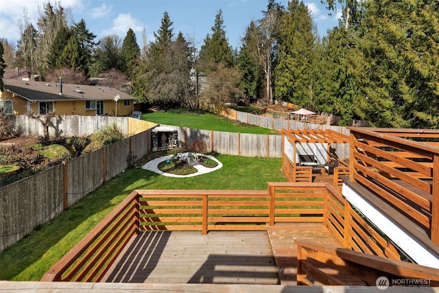 deck featuring a lawn, a fenced backyard, and a pergola