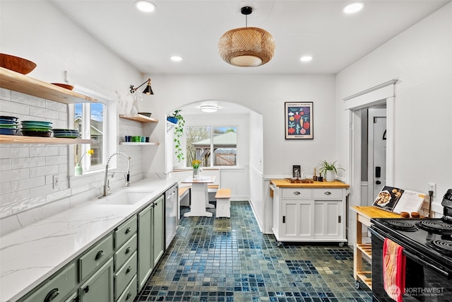 kitchen featuring a sink, green cabinets, stainless steel dishwasher, black electric range, and open shelves