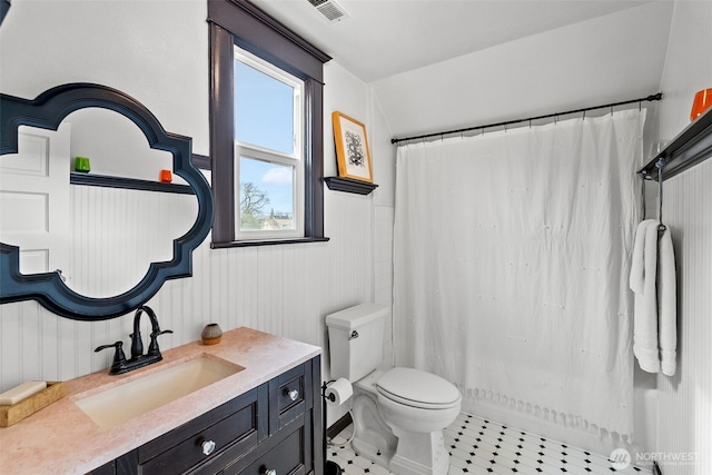 bathroom featuring vanity, toilet, visible vents, and tile patterned flooring