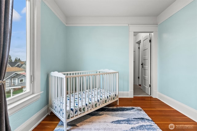 bedroom featuring baseboards and wood finished floors