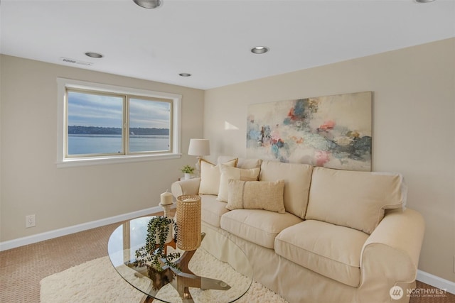 living area featuring baseboards, visible vents, a water view, carpet flooring, and recessed lighting