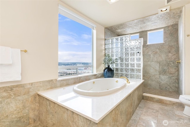 full bathroom with a whirlpool tub, plenty of natural light, a walk in shower, and toilet