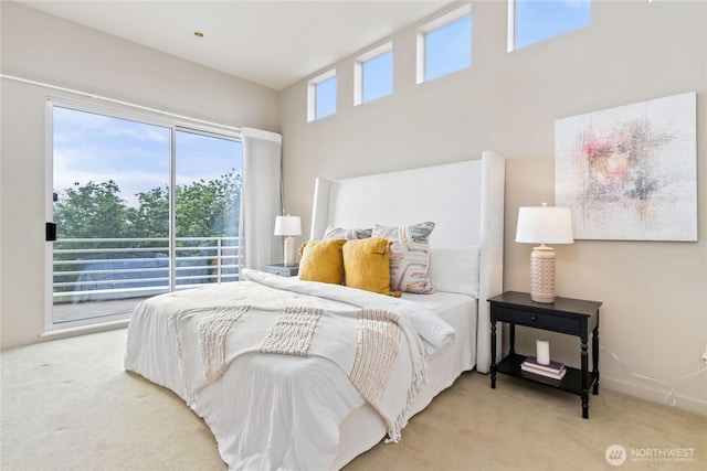 carpeted bedroom featuring access to outside and baseboards