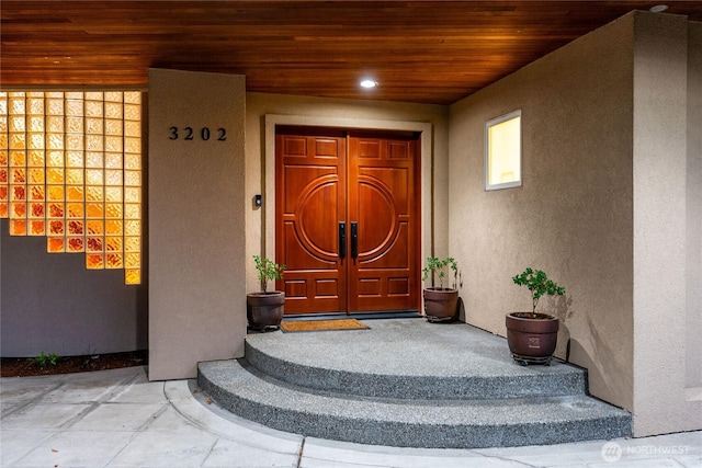 entrance to property featuring stucco siding