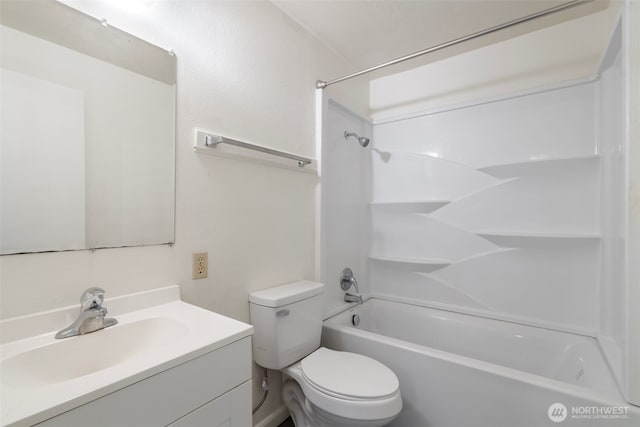 bathroom with washtub / shower combination, vanity, and toilet