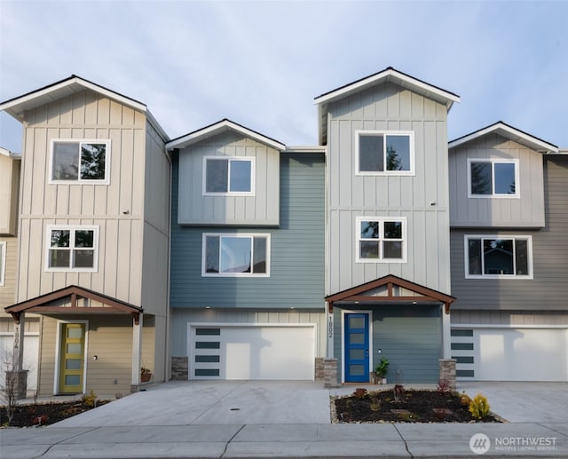 view of front facade featuring board and batten siding, concrete driveway, and a garage