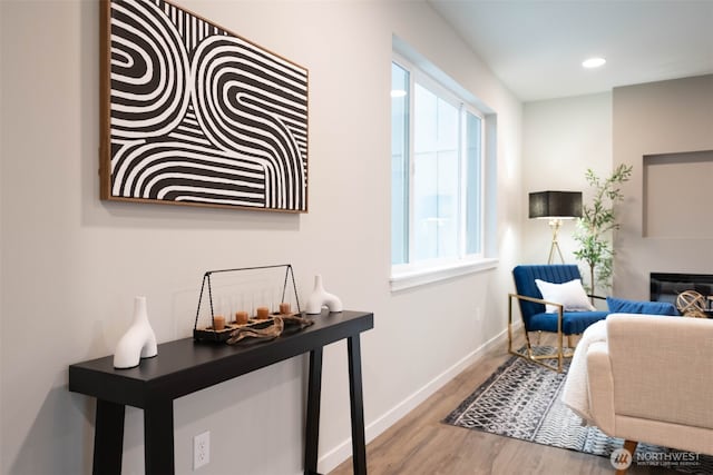 sitting room featuring a fireplace, recessed lighting, wood finished floors, and baseboards